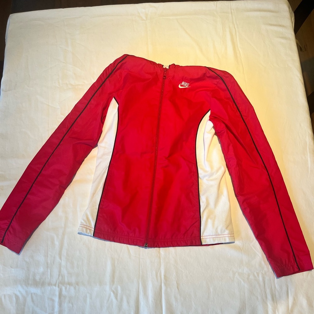 Red and white Nike Sportswear windbreaker with hood.